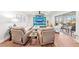 Elegant living room featuring plush sofas, modern decor, and access to an outdoor balcony at 101 Whispering Sands Dr # 307, Sarasota, FL 34242