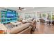 Comfortable living room with modern furnishings, entertainment center, and sliding doors to a balcony at 101 Whispering Sands Dr # 307, Sarasota, FL 34242