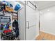 Hallway storage area with a custom barn door and shelving for holding shoes and gear at 101 Whispering Sands Dr # 307, Sarasota, FL 34242