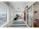 Bright sunroom with shutters, ceiling fan, desk, and access to bedroom with bunkbeds at 101 Whispering Sands Dr # 307, Sarasota, FL 34242