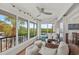 Relax in this sunroom featuring tropical views, comfortable seating, and abundant natural light at 101 Whispering Sands Dr # 307, Sarasota, FL 34242