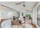 Bright sunroom with stylish seating area, wood floors, and sliding glass doors leading to living space at 101 Whispering Sands Dr # 307, Sarasota, FL 34242