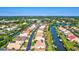 Waterfront community homes on canals with private docks and lush green landscaping under a blue sky at 105 Inlets Blvd # 105, Nokomis, FL 34275