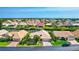 Waterfront homes with well-kept lawns and landscaping in a canal community under a blue sky at 105 Inlets Blvd # 105, Nokomis, FL 34275