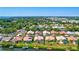Waterfront homes with docks, lush landscaping, and screened-in pools under a bright blue sky at 105 Inlets Blvd # 105, Nokomis, FL 34275