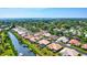 Waterfront community homes on canals with docks and scenic views under a clear blue sky at 105 Inlets Blvd # 105, Nokomis, FL 34275
