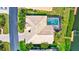 Overhead aerial view of the property showing the house layout, pool, tile roof, dock, and surrounding neighborhood at 105 Inlets Blvd # 105, Nokomis, FL 34275