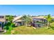 Aerial view of the backyard featuring a screened-in pool area, lush green lawn, and well-manicured landscaping at 105 Inlets Blvd # 105, Nokomis, FL 34275