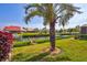 Scenic backyard featuring tropical landscaping, canal frontage, and private dock access for boating enthusiasts at 105 Inlets Blvd # 105, Nokomis, FL 34275