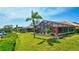 Beautiful backyard with screened lanai, pool, lush landscaping, and canal access, perfect for waterfront living at 105 Inlets Blvd # 105, Nokomis, FL 34275