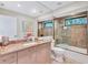 Well-lit bathroom featuring a granite countertop and tiled shower with glass doors at 105 Inlets Blvd # 105, Nokomis, FL 34275