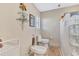 Bathroom with a toilet, bidet, and glass block detailing in the shower at 105 Inlets Blvd # 105, Nokomis, FL 34275