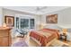 Comfortable bedroom with a bay window, art, and hardwood floors at 105 Inlets Blvd # 105, Nokomis, FL 34275