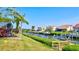 Waterfront view of a house on the canal with a private boat dock and lush, green landscaping at 105 Inlets Blvd # 105, Nokomis, FL 34275