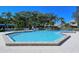 Spacious community pool with lush greenery and well-maintained brick, offering a perfect oasis for relaxation at 105 Inlets Blvd # 105, Nokomis, FL 34275