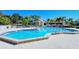 Spacious community pool with lush landscaping, offering a perfect oasis for relaxation and recreation at 105 Inlets Blvd # 105, Nokomis, FL 34275