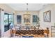 Elegant dining room with glass table, modern chairs, and access to outdoor patio at 105 Inlets Blvd # 105, Nokomis, FL 34275