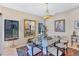 Dining area with glass table set, elegant chandelier, and large mirror reflecting kitchen at 105 Inlets Blvd # 105, Nokomis, FL 34275