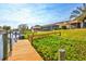 Private dock overlooking the waterway and landscaped yard, providing a serene setting for waterfront enjoyment at 105 Inlets Blvd # 105, Nokomis, FL 34275