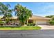 Charming single-story home with a two-car garage, beautiful landscaping, and a well-maintained front yard at 105 Inlets Blvd # 105, Nokomis, FL 34275