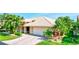 Well-maintained exterior with mature landscaping and a brick driveway leading to a spacious two-car garage at 105 Inlets Blvd # 105, Nokomis, FL 34275