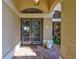 Close-up of an elegant front door with decorative glass panels and a charming welcome mat at 105 Inlets Blvd # 105, Nokomis, FL 34275