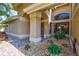 Inviting front porch with decorative stone landscaping, elegant pillars, and a stylish front door at 105 Inlets Blvd # 105, Nokomis, FL 34275