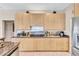 Modern kitchen with granite countertops and stainless steel appliances and ample cabinet space at 105 Inlets Blvd # 105, Nokomis, FL 34275