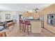 Well-lit kitchen with a center island and stainless steel appliances, connecting to the dining area at 105 Inlets Blvd # 105, Nokomis, FL 34275