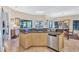 Open kitchen with granite countertops and stainless steel dishwasher at 105 Inlets Blvd # 105, Nokomis, FL 34275