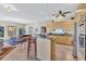 Open-concept kitchen featuring a large island and stainless steel appliances at 105 Inlets Blvd # 105, Nokomis, FL 34275