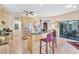 Open kitchen with granite countertops, stainless steel appliances, and island with bar seating at 105 Inlets Blvd # 105, Nokomis, FL 34275