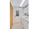Bright laundry room with washer, dryer, storage cabinets, and access door at 105 Inlets Blvd # 105, Nokomis, FL 34275