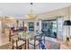 Open-concept area with dining table and kitchen view, leading to outdoor patio and pool at 105 Inlets Blvd # 105, Nokomis, FL 34275
