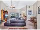 Spacious living room with high ceilings, a ceiling fan, and a large leather sofa overlooking the patio at 105 Inlets Blvd # 105, Nokomis, FL 34275
