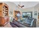 Bright living room featuring a vaulted ceiling, custom shelving, and a comfortable seating area at 105 Inlets Blvd # 105, Nokomis, FL 34275
