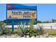 North Jetty Park sign surrounded by native plants and clear blue skies at 105 Inlets Blvd # 105, Nokomis, FL 34275