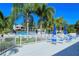 Community pool deck with ample seating and tables, perfect for relaxing and enjoying the Florida sunshine at 105 Inlets Blvd # 105, Nokomis, FL 34275
