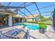 Backyard pool area features a screened enclosure and a serene, landscaped setting at 105 Inlets Blvd # 105, Nokomis, FL 34275