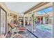 Covered patio area boasts comfortable seating and views of the inviting screened-in pool at 105 Inlets Blvd # 105, Nokomis, FL 34275