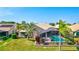 Backyard view of screened-in pool and patio area, landscaping, and tile roof with solar panels, perfect for outdoor living at 105 Inlets Blvd # 105, Nokomis, FL 34275