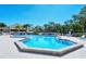 Inviting community swimming pool with ample space, lounge chairs and umbrellas, perfect for relaxing in style at 105 Inlets Blvd # 105, Nokomis, FL 34275