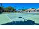 Community tennis courts with shade structure for spectators and additional shade trees nearby at 105 Inlets Blvd # 105, Nokomis, FL 34275