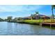 Canal view of the rear of waterfront homes, private docks, boat lifts, and screened-in lanais at 105 Inlets Blvd # 105, Nokomis, FL 34275