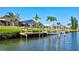 Canal view of waterfront homes with docks, boat lifts, screened lanai and lush landscaping at 105 Inlets Blvd # 105, Nokomis, FL 34275