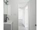 Bright bathroom with modern vanity, sink, and fixtures with a view into the hall at 115 41St Ne Ave, St Petersburg, FL 33703