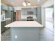 Spacious kitchen featuring gray cabinets, stainless steel appliances, white countertops, and a center island at 115 41St Ne Ave, St Petersburg, FL 33703