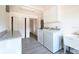 Well-lit laundry room with modern washer and dryer, storage cabinets, and countertop space at 115 41St Ne Ave, St Petersburg, FL 33703
