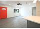 Bright living room with light gray flooring, fresh white walls, and a contrasting orange front door at 115 41St Ne Ave, St Petersburg, FL 33703