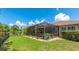 Lush backyard with a screened-in patio, offering a private and serene outdoor retreat at 11625 Parrotfish St, Venice, FL 34292